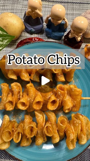 potato chips on a blue plate next to small figurines and other food items