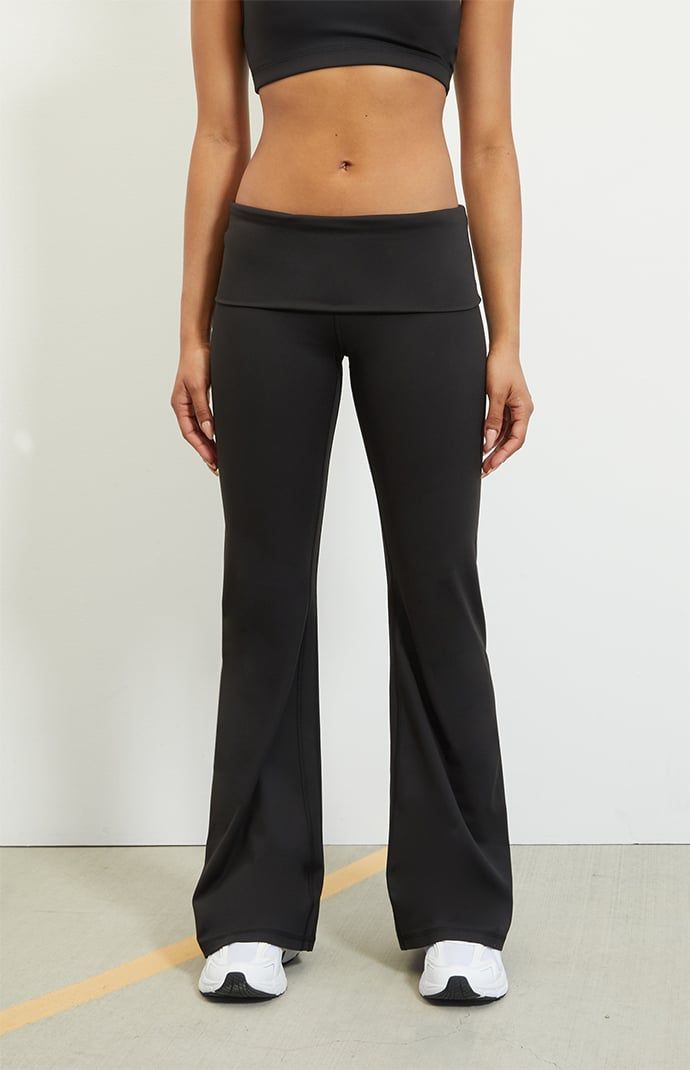 The PAC WHISPER Active Fold-Over Waistband Flare Yoga Pants from the PAC 1980 activewear collection make for the perfect piece for your next workout routine. These low-rise leggings have a fold-over waistband with flared leg openings and a tight figure-flattering fit. This piece is made with our PAC WHISPER™ fabric and has a buttery soft feel and quick-drying design that is perfect for working out or lounging around.   	Solid color leggings 	7" rise 	31.5" inseam 	22" leg opening 	Buttery soft 	Quick-drying 	4-way stretch 	24/7 comfort 	Low-rise 	Fold-over waistband 	Flared leg openings 	Tight fit 	HD silicone P logo 	Fits true to size 	82% polyester, 18% spandex 	Model is wearing a size XS 	PAC WHISPER™: Buttery soft and quick-drying. Perfect from the studio to Fold Over Yoga Pants, P Logo, Color Leggings, Low Rise Leggings, Flare Yoga Pants, Outfit Collage, Flared Leggings, Yoga Pants Outfit, Flare Leggings