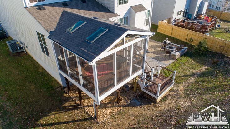 an aerial view of a house with a deck and screened in porches on the side