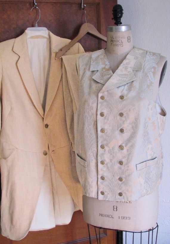 Note: We can make all types of frock coats and vests. Just contact us if you have a different style in mind.  ------------------------------------------------------------   This listing is for a 3-Piece suit with an Edwardian style frock coat, made from a genuine vintage pattern.  The jacket and the pants are made from a wheat colored linen and the double breasted vest is made from a stunning brocade.  The frock coat is a gently cut-away front morning coat with two buttons and longer narrow l... Fitted Spring Suit With Vest, Spring Tailored Vest With Buttons, Sleeveless Vest With Buttons For Wedding, Fitted Vest With Buttons For Wedding, Elegant Daywear Vest With Buttons, Fitted Wedding Vest With Buttons, Fitted Daywear Vest With Buttons, Fitted Vest With Buttons For Daywear, Fitted Beige Vest For Tailoring