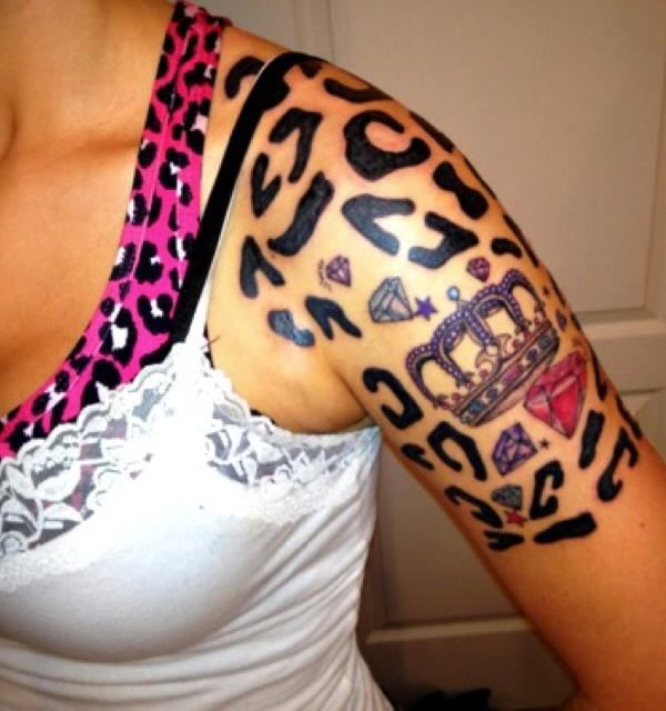 a woman with a leopard print tattoo on her arm