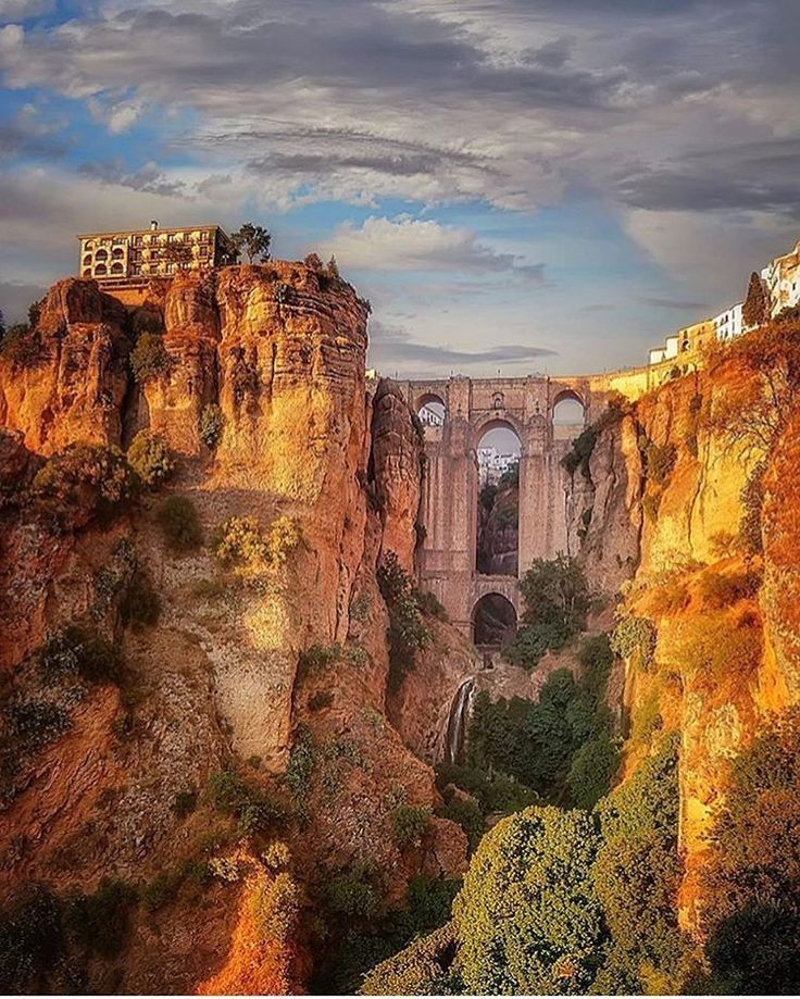 an old bridge built into the side of a cliff