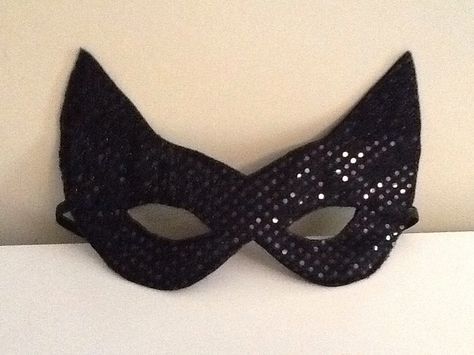 a black cat mask with sequins on it