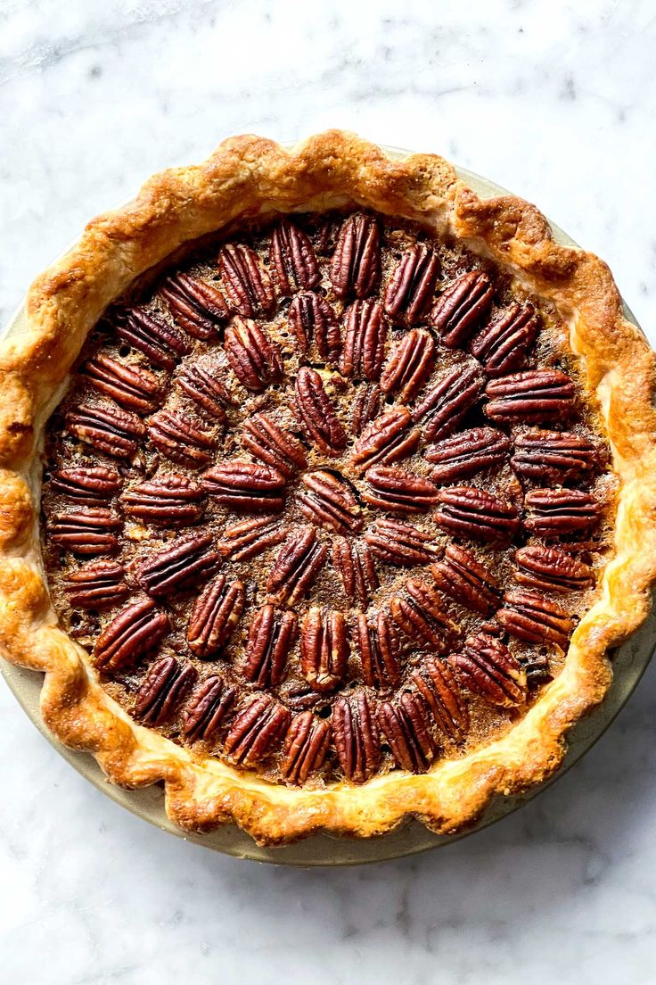 a pecan pie on a marble table