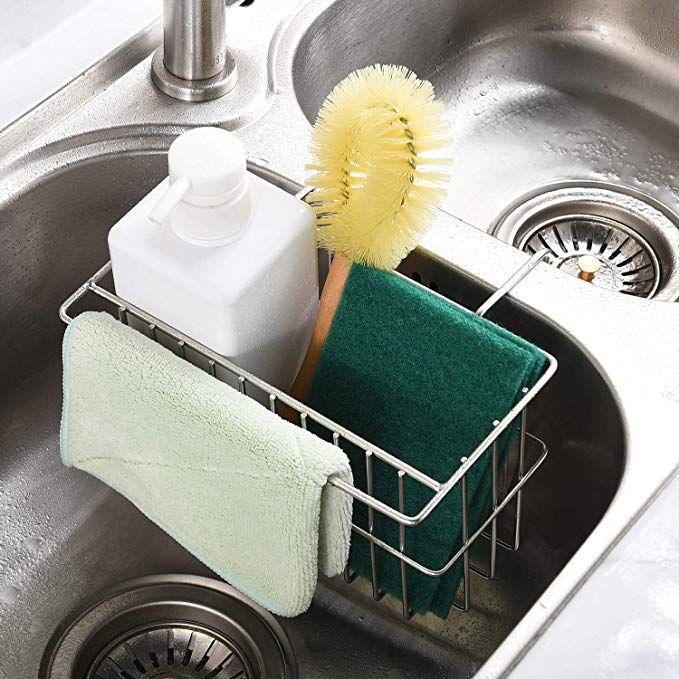 a cleaning brush and sponge in a sink