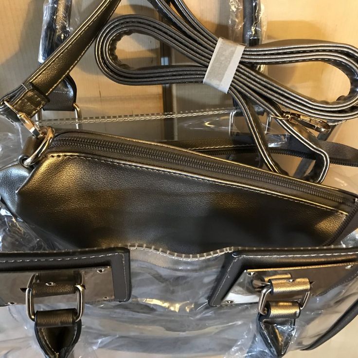 This satchel and tote handbag is 2-in-1. It's a transparent satchel tote with a complimentary removable shoulder bag. This bag is awesome! If you love chic bags, this is the perfect bag for you!

2-day processing. Shipped in 4-7 days. School Tote Shoulder Bag With Clear Strap, Trendy Clear Bags For On-the-go, School Tote Bag With Clear Strap, Everyday Shoulder Bag With Clear Strap Satchel, Everyday Satchel With Clear Strap And Crossbody Shape, Travel Crossbody Satchel With Clear Strap, Everyday Satchel With Clear Crossbody Strap, Rectangular Travel Satchel With Clear Strap, Everyday Use Satchel Shoulder Bag With Clear Strap