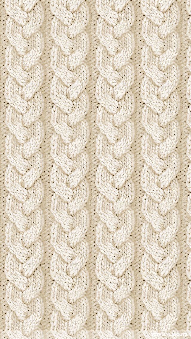 a knitted blanket with braiding on the bottom and sides, in beige tones