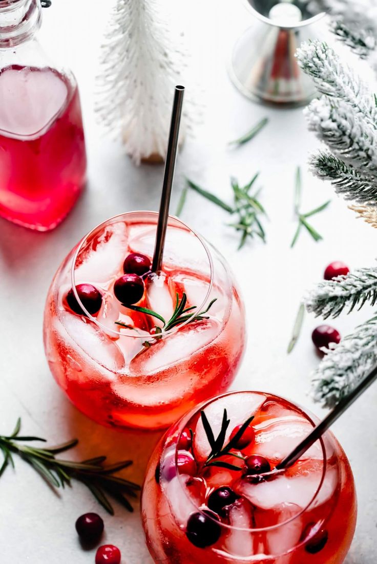 winter aperol spritz cocktail with rosemary garnish and ice in glasses