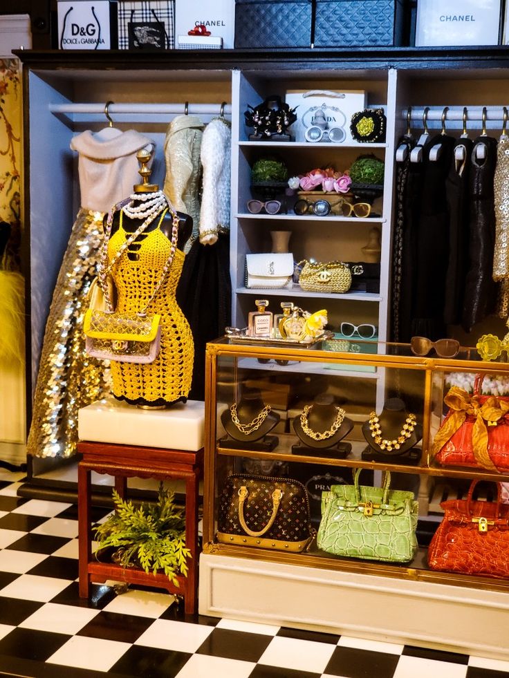 a closet with lots of purses and handbags on display next to a checkered floor