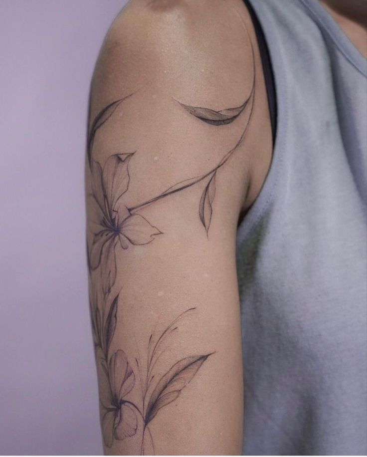 a woman with a flower tattoo on her arm