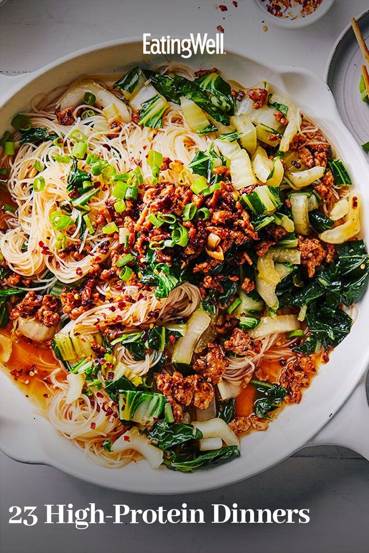 a white bowl filled with pasta and vegetables