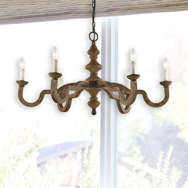 a wooden chandelier hanging from a window