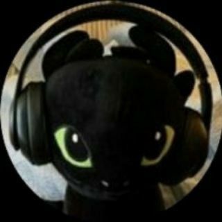 a black cat wearing headphones with green eyes