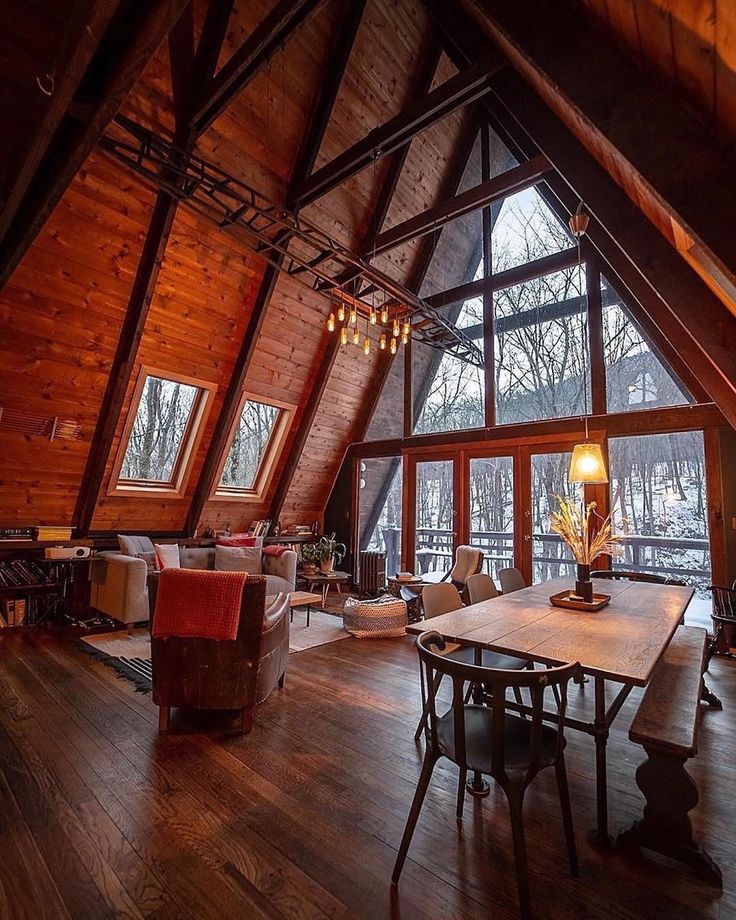 a loft with wood floors and large windows