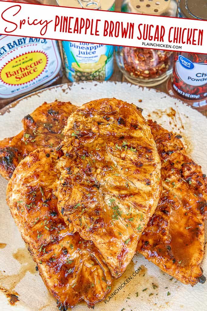 three pieces of pineapple brown sugar chicken on top of a white plate next to cans of sauce