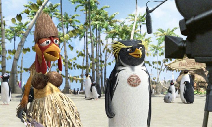 the penguins are standing in front of an outdoor movie set with trees and palm trees behind them