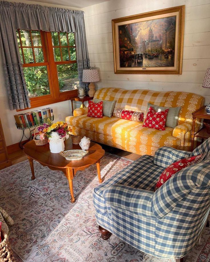 a living room filled with furniture and a painting on the wall