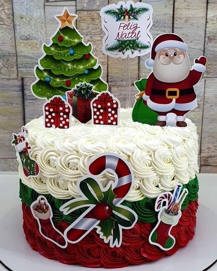 a decorated christmas cake with santa clause on top