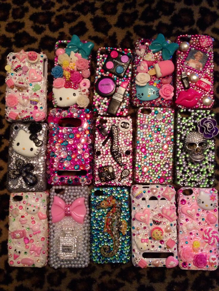 many different cell phones are lined up on a leopard print surface with hello kitty and other accessories