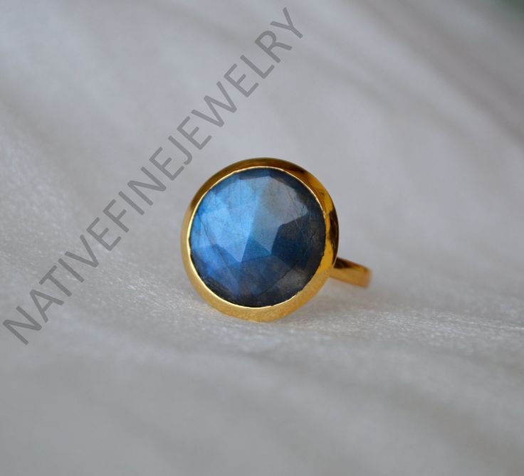 "Checker Cut Blue Fire Labradorite gold ring,14k yellow gold ring, Labradorite jewelry,romantic gift ring,gold ring, gift for her,Labradorite {Please see last image for gemstone selection} Labradorite is known for its qualities of \"magic\" including clairvoyance, psychic powers, telepathy, communication with higher and inner wisdom and guides. Known as a gemstone of adventure, Labradorite is said to help one set off and move swiftly on the inner path and on higher journeys. The 14K yellow solid gold bezel and solid yellow gold ring are both shined to an extremely high polish. All rings are packaged and shipped in a beautiful ring box.  The main stone is natural, shiny, cut Labradorite. Gemstone Size Approx : 16 mm {Please see last image for gemstone selection} The pictures have been enlar Gold Sapphire Cabochon Ring As Gift, Gold Labradorite Rings For Anniversary, Yellow Gold Labradorite Round Jewelry, Luxury Moonstone Ring Gift With Bezel Setting, Luxury Faceted Rings As Gift, Luxury Faceted Ring As Gift, Luxury Faceted Gift Ring, Round Labradorite Ring As Gift, Luxury Moonstone Cabochon Ring As Gift