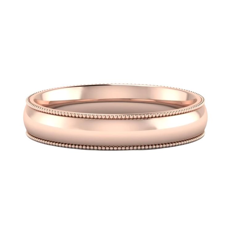 a rose gold wedding ring with beading on the sides and an engraving pattern in the middle