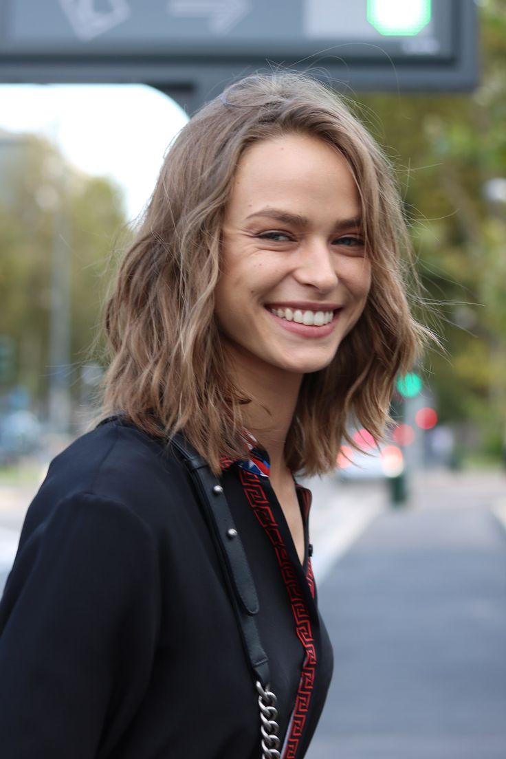 a woman with shoulder length hair smiling at the camera