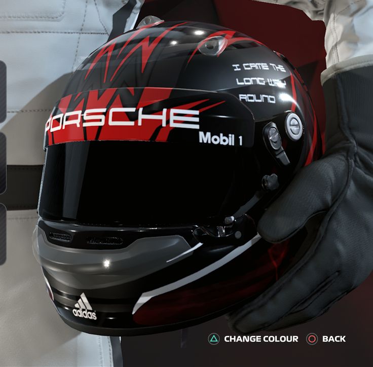 a person wearing a black and red helmet with the words porsche on it