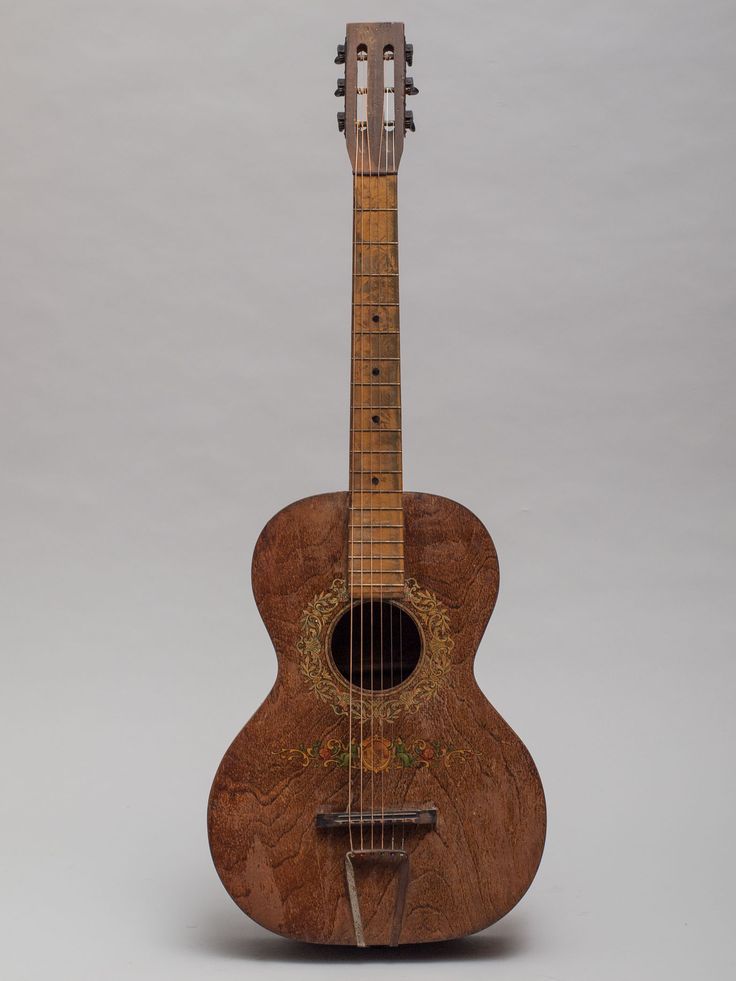 a small wooden guitar sitting on top of a table