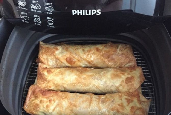 two burritos sitting on top of an air fryer