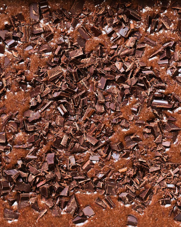 a chocolate cake with lots of broken pieces on the top and bottom, in a pan