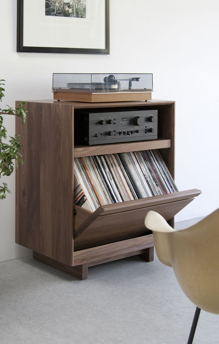 an old record player sitting on top of a wooden cabinet