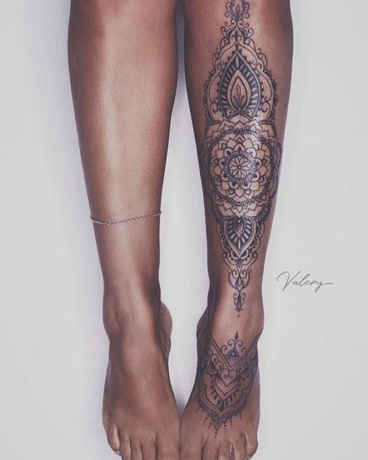 a woman's legs with tattoos on them