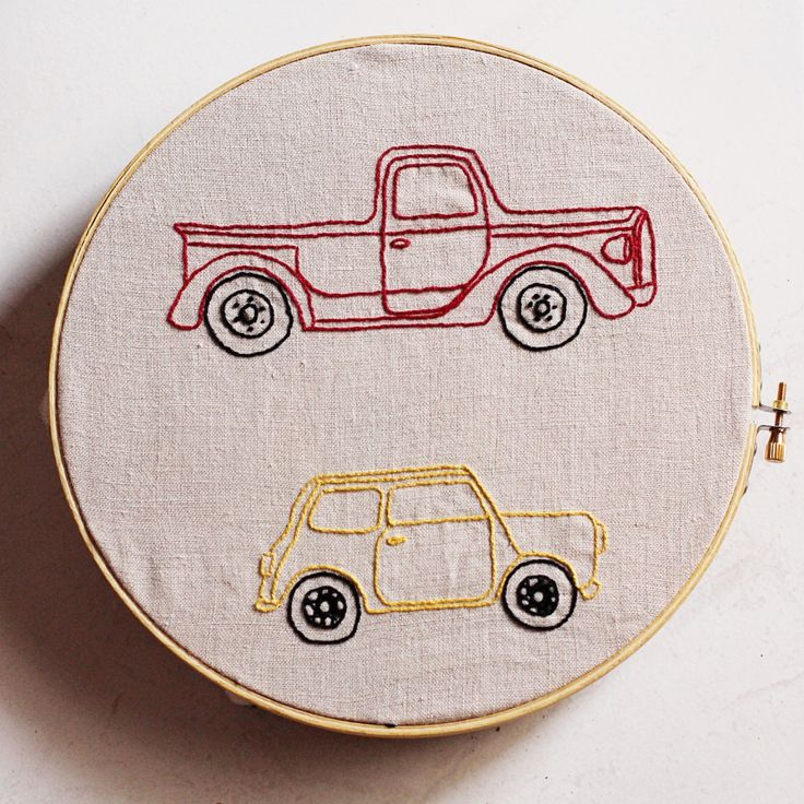 two cars are depicted on a white background in this embroidery pattern, which includes a red truck and a yellow car