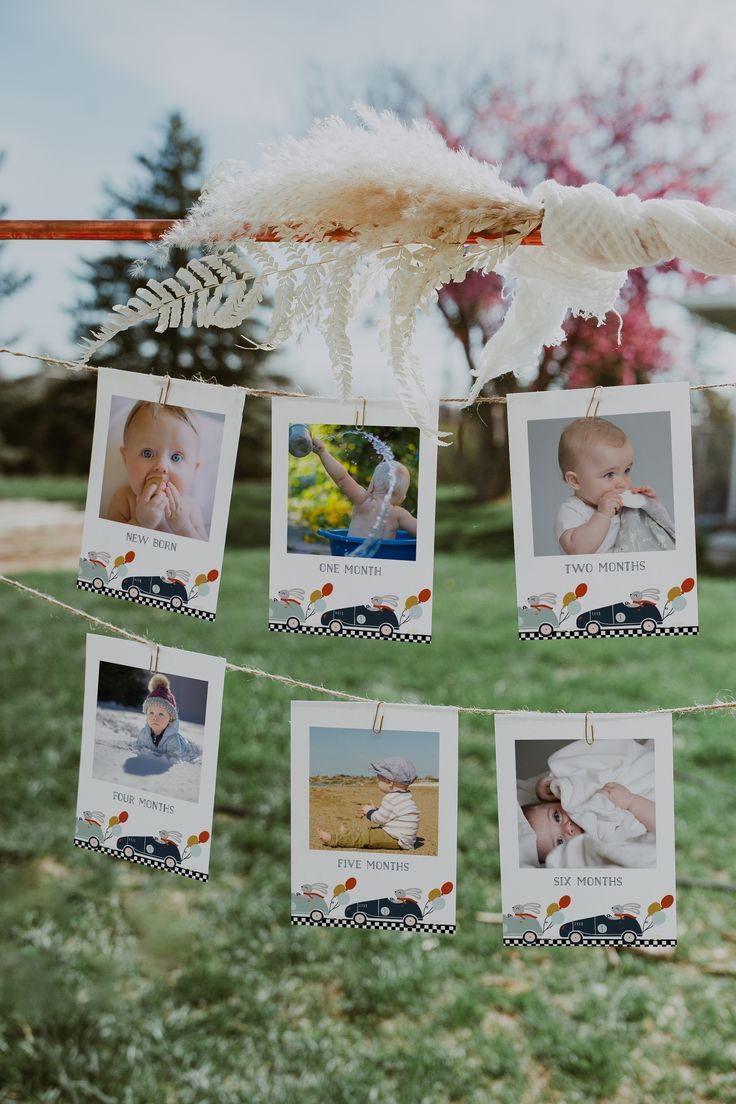 the baby's photos are hung on a clothes line with feathers hanging from them