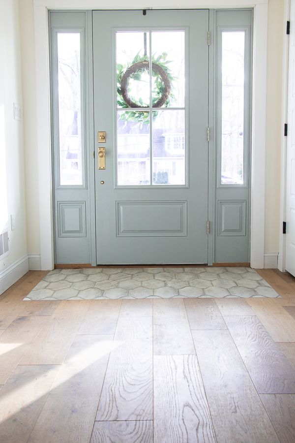 a blue front door with a wreath on it