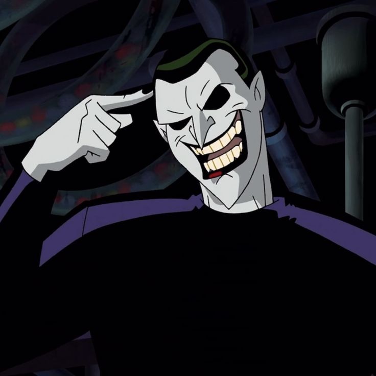 the joker is smiling and pointing to his left side with one hand on his head