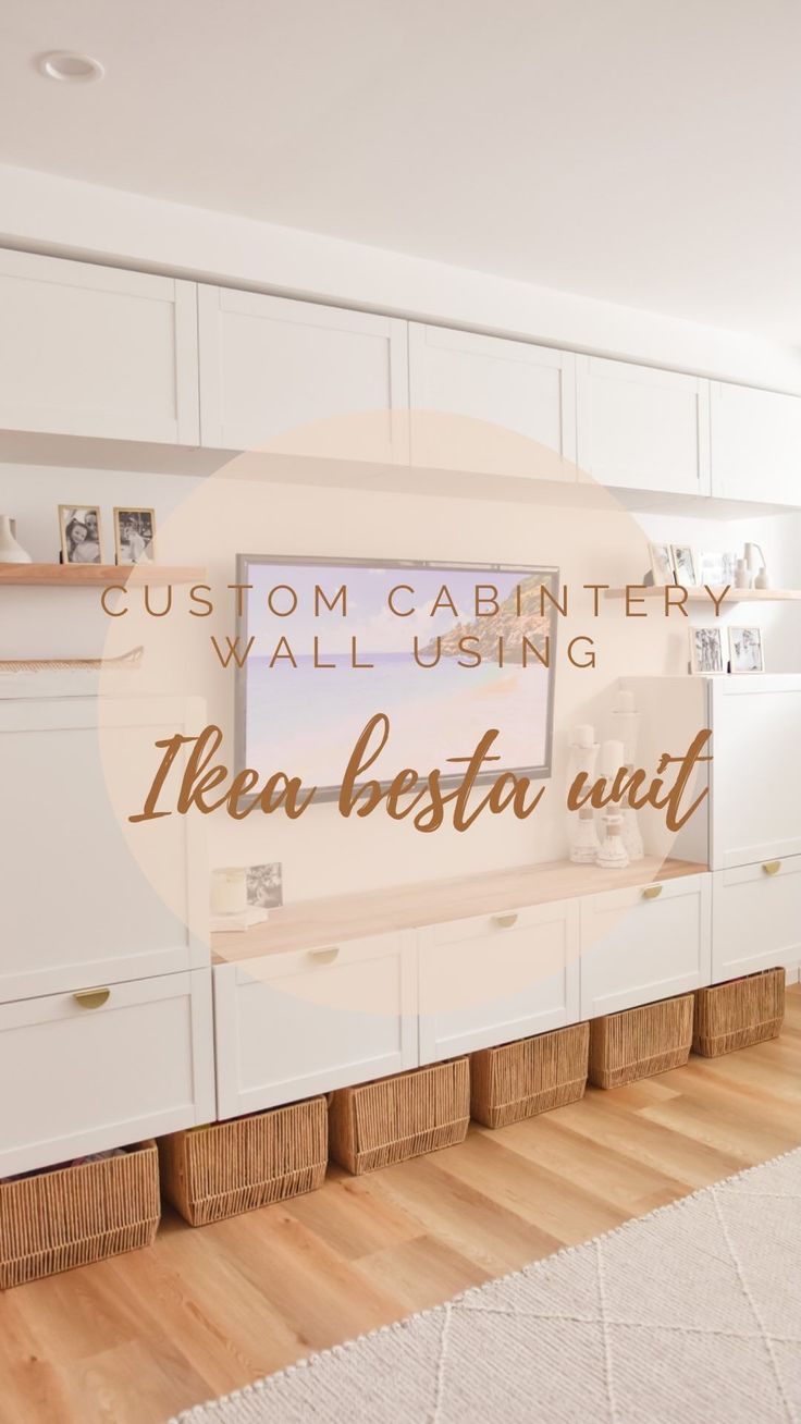 a white kitchen with wooden floors and cabinets in front of a window that reads custom cabinetry wall using ikea besta unit