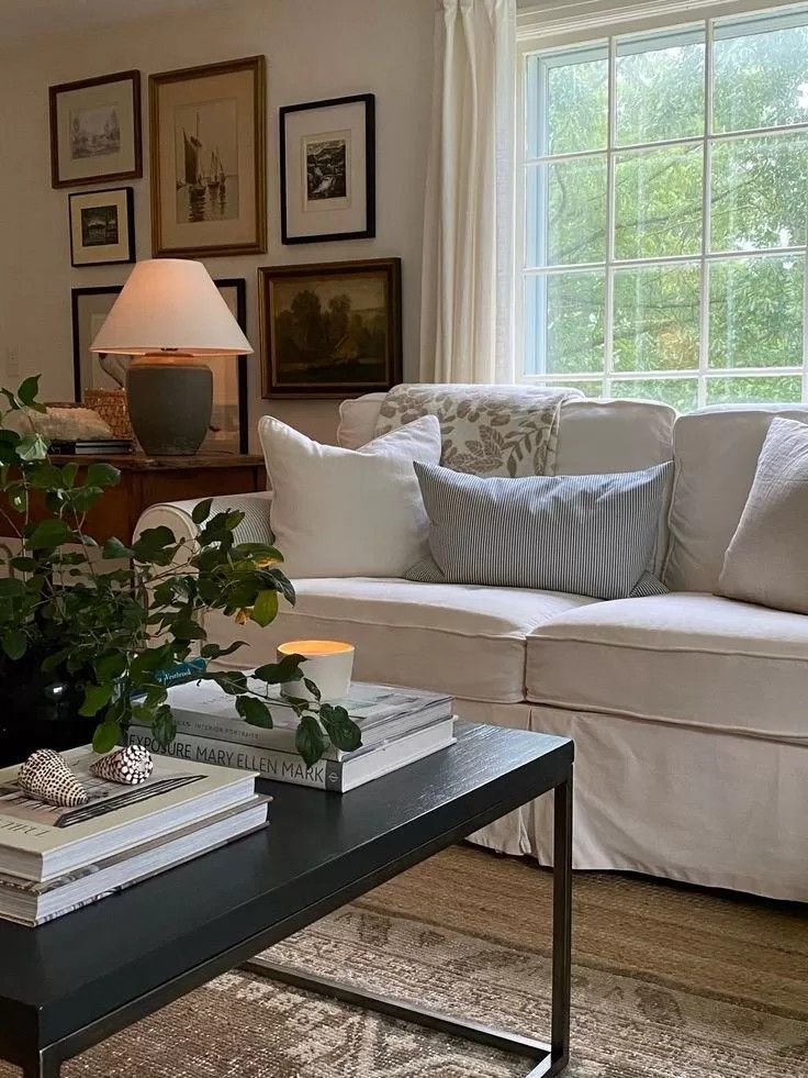 a living room filled with furniture and a large window