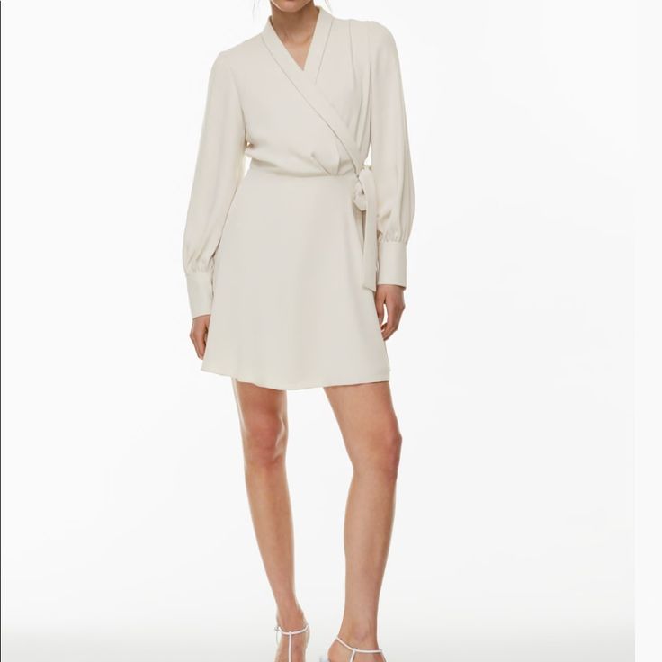 Brand New/Never Worn Aritzia Babaton Hyde Mini Dress Color: Matte Pearl Size: Medium (Tts) Passed The Return Date & No Longer Needed This Is A Collared Mini Wrap Dress With Button-Closure Cuffs And A Waist Tie. It’s Made With Studio Drape Drapey Matte Satin With A Smooth Look And Lightweight Feel. Elegant A-line Wrap Dress For Date Night, Elegant Summer Mini Dress In Viscose, Elegant Viscose Mini Dress For Summer, Elegant Long Sleeve Neutral Mini Dress, Summer Formal Mini Wrap Dress, Elegant Fitted Viscose Wrap Dress, Elegant White Long Sleeve Wrap Dress, Elegant Spring Viscose Wrap Dress, Elegant Viscose Mini Dress For Fall