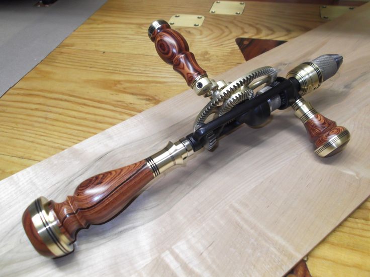 a close up of a wooden object on a table with wood and metal parts around it