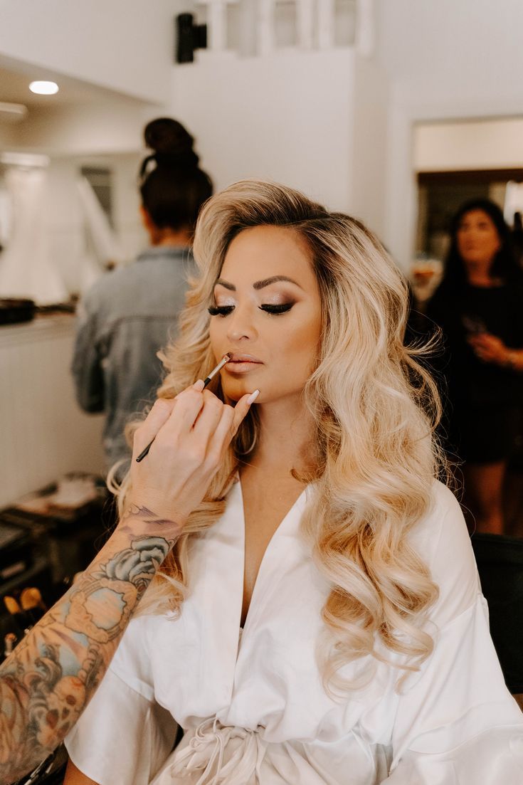 a woman is getting her makeup done in the salon