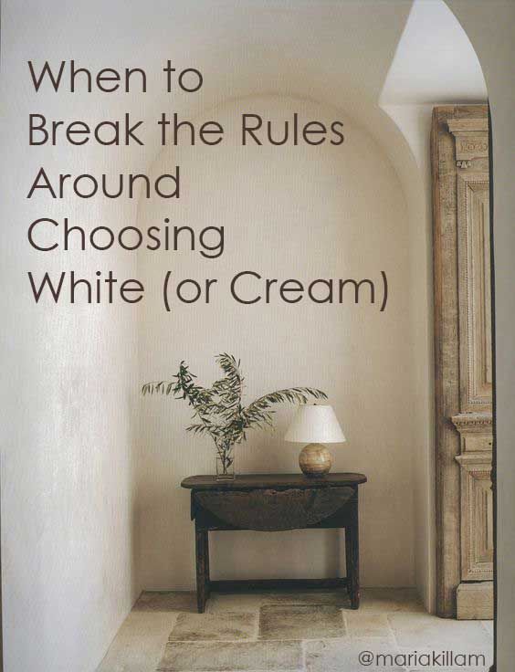 an advertisement for white cream on the side of a wall with a table and lamp