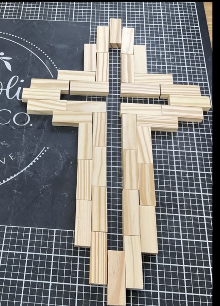 a cross made out of wood sitting on top of a blackboard with the words hope in white lettering