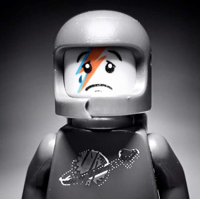 a black and white photo of a lego figure with an angry look on his face