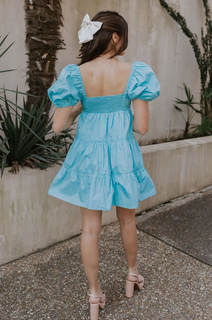 #html-body [data-pb-style=XHSCQEK]{justify-content:flex-start;display:flex;flex-direction:column;background-position:left top;background-size:cover;background-repeat:no-repeat;background-attachment:scroll} The Gloria Light Blue Short Sleeve Mini Dress, a captivating ensemble that effortlessly combines sophistication with playful charm. Crafted from exquisite aqua blue cotton fabric, this dress exudes a sense of freshness and vibrancy, perfect for embracing sunny days and breezy evenings. The mini-length silhouette adds a flirty touch, while the aqua blue lining ensures comfort and coverage. Adorned with charming ruffle tiered details, the dress exudes an air of femininity and grace, creating subtle movement with every step. A sweetheart neckline adorned with delicate drawstring ties, allow Blue Cotton Fabric, Light Blue Shorts, Short Sleeve Mini Dress, Jumpsuit Shorts Rompers, Maxi Dresses Casual, Hoco Dresses, Tie Dress, Mini Dress With Sleeves, Spring Dresses