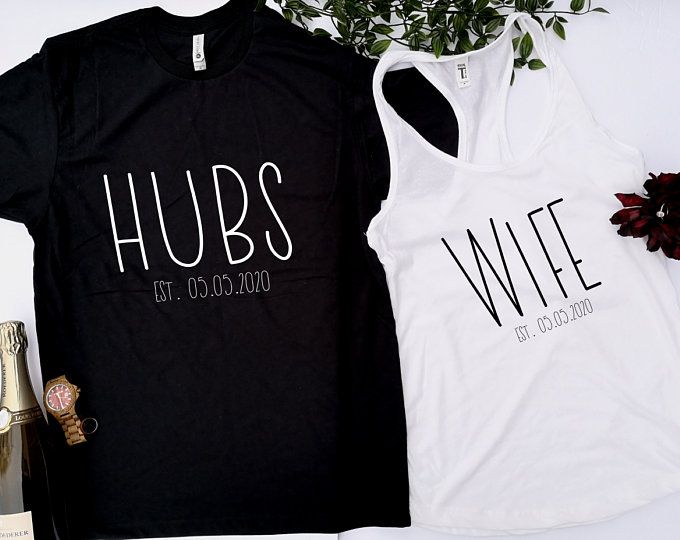 two t - shirts with the words hubs and wife on them next to a bottle of champagne