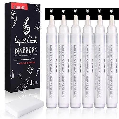 six white markers are in front of a black box and the package is next to it