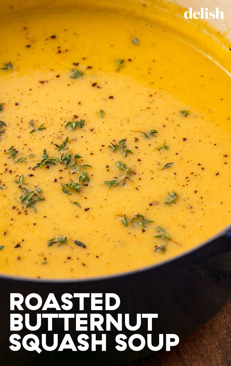 a bowl of roasted butternut squash soup on a wooden table with text overlay reading roasted butternut squash soup