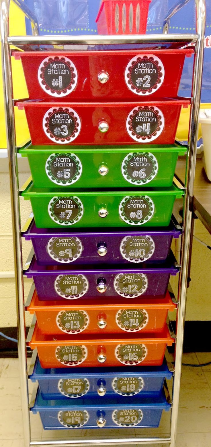 a stack of colorful plastic containers sitting on top of a metal rack