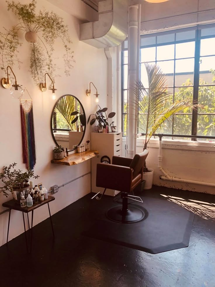 a chair and mirror in a room with plants hanging on the wall next to it